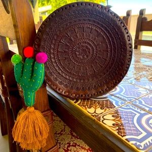 Round hand tooled leather bag with cactus tassel